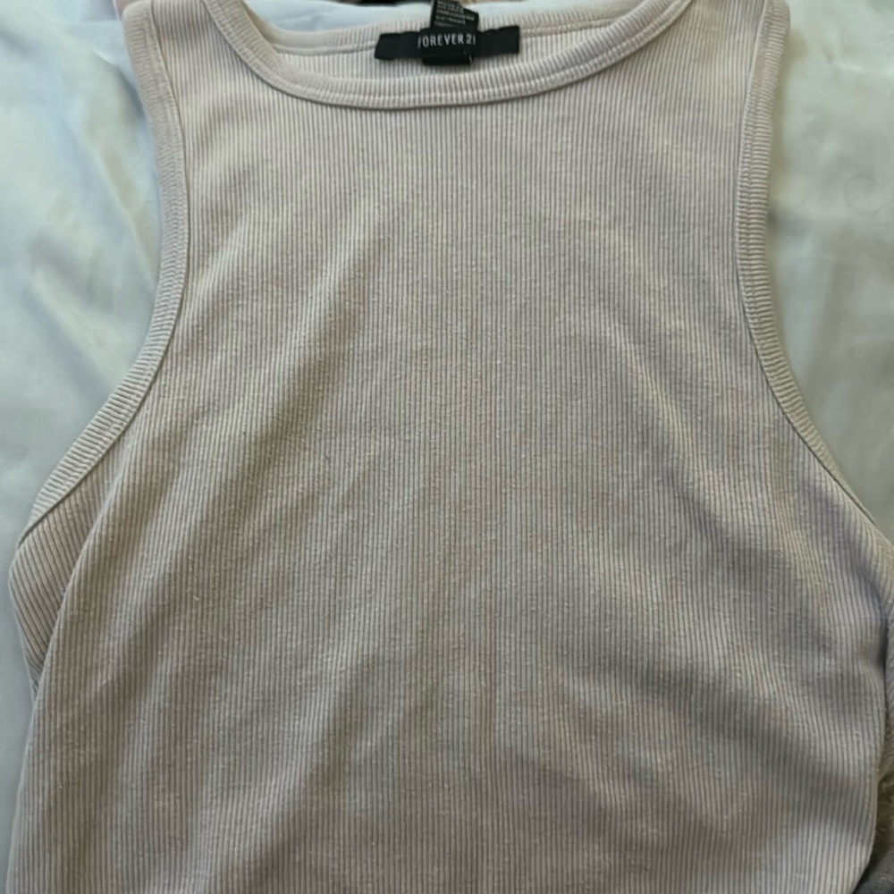A cute light brown tank top with lil waves on the bottoms.